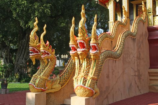 The three-headed serpent statue. Entrance to the church, a temple in Chiang Mai, Thailand.