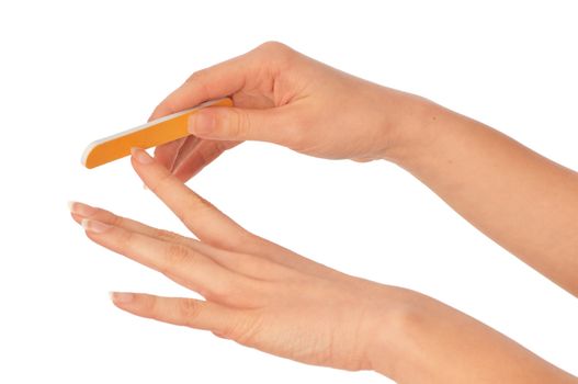 woman files her nails by emery board from manicure set
