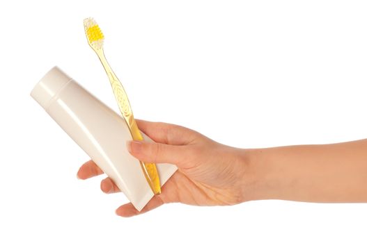 Tooth-paste and brush at in the girl's hand