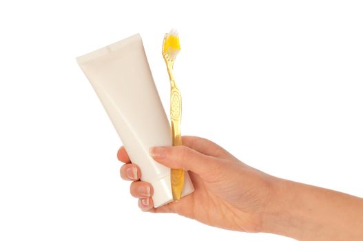 Tooth-paste and brush at in the girl's hand