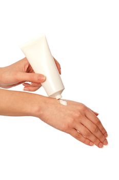 woman lubricates the hands skin with cosmetic cream