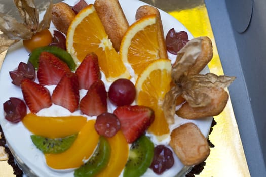 Fruit cake with orange, kiwi, grapes, strawberry.