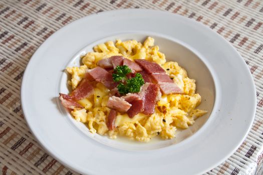 Roasted egg, sprinkle with bacon on white dish.