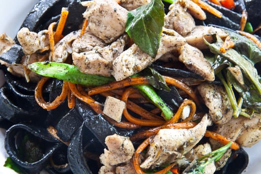 Stir in spaghetti, black lines. A spicy. thai style.