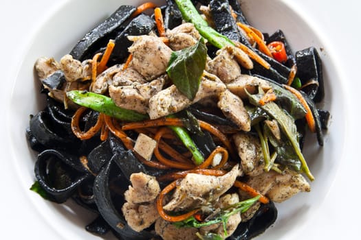 Stir in spaghetti, black lines. A spicy. thai style.
