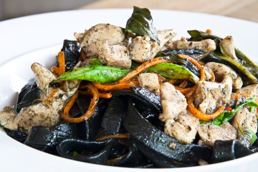 Stir in spaghetti, black lines. A spicy. thai style.
