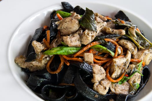 Stir in spaghetti, black lines. A spicy. thai style.