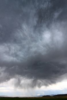 Dark clouds and precipitation from a thunderstorm in rural Idaho.