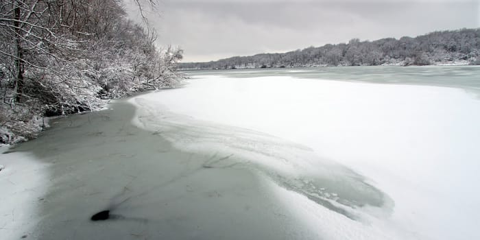 Shoreline of Pierce Lake on a snowy winter day at Rock Cut State Park in Illinois.