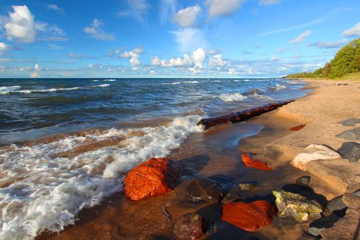 Beach of Lake Superior in northern Michigan under beautiful evening sunlight.