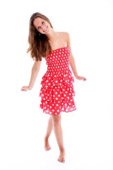 Beautiful carefree barefoot teenager with a vivacious smile walking across the frame in a pretty red and white polka dot sundress Beautiful carefree barefoot teenagerwith a vivacious smile walking across the frame in a pretty red and white polka dot sundress 