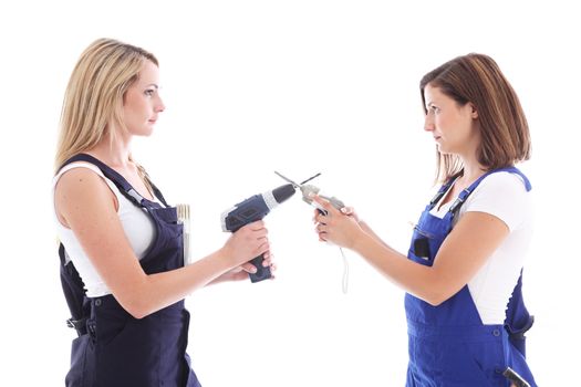 Humorous image of two DIY housewives facing off to a duel as they stand face to face with crossed power tools 