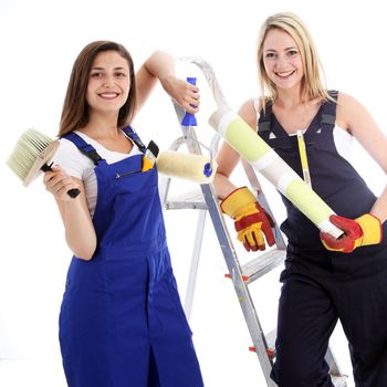 Two happy confident woman decorators posing with their equipment for a wallpapering project on a white background Two happy confident woman decorators posing with their equipement for a wallpapering project on a white background 