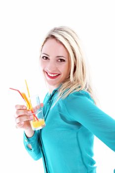 Beautiful happy young female tourist smiling in elation as she drinks tropical orange cocktail on summer vacation 