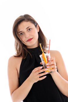 Low angle view of a serious sophisticated woman in a black halter neck dress enjoying a glass of tropical orange cocktail isolated on white 