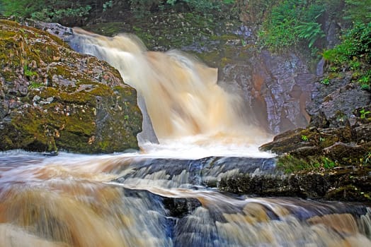 Snow Falls on the River Doe near Ingleton in Yorkshire, England.