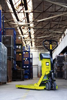 yellow pallet jack in the industrial warehouse