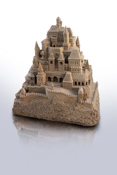 large isolated sandcastle with many towers and crenels