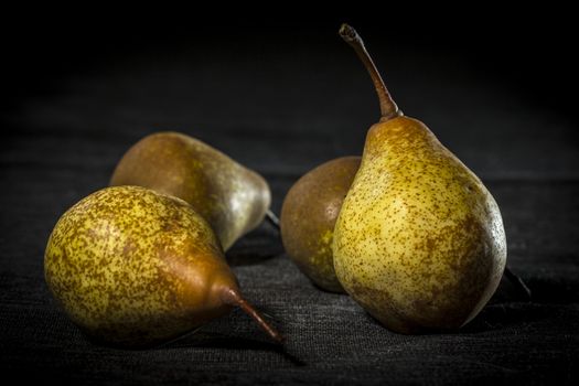 Organic pears on dark background, dramatic lights