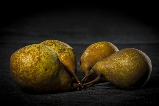 Organic pears on dark background, dramatic lights