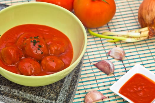 Bowl with meatballs and tomato sauce