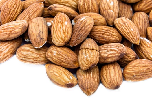 Heap of almonds isolated on white background