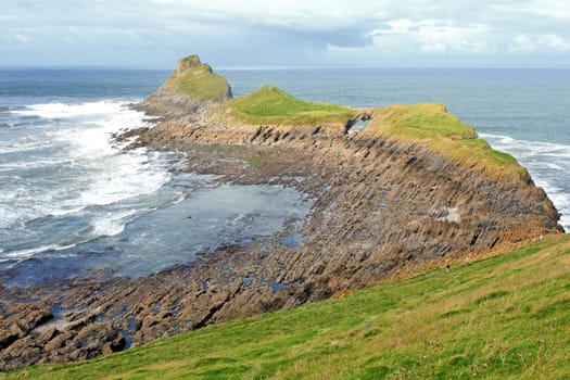 Wiew of Worms Head in Gower, Wales, coastline on a sunny day