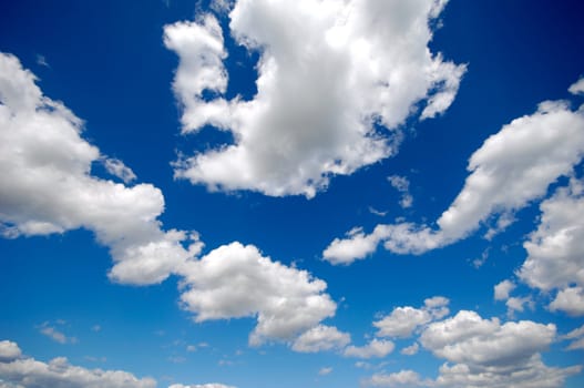 White cumulus clouds and a blue sky