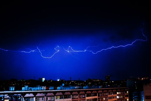 Dazzle lightning over the city at night. Sky before the storm