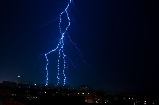 vertical lightning over the city at night. Sky before the storm