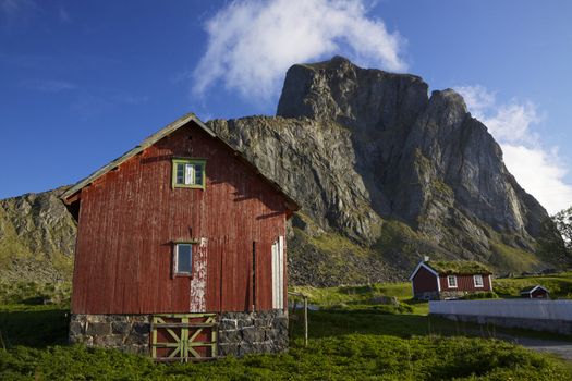 Traditional red wooden houses in norwegian village Nordland on island of Vaeroy, Lofoten