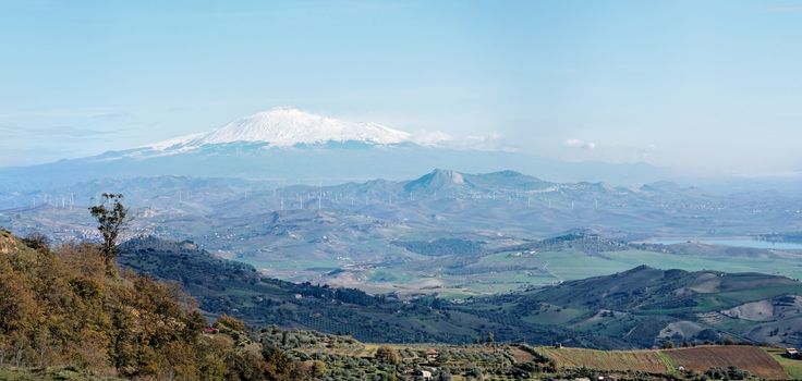 Sicilian rural landscape in winter with snow peak of Etna volcano in Italy