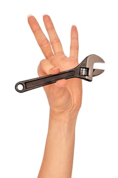 woman holding small chrome vanadium adjustable spanner in the hand