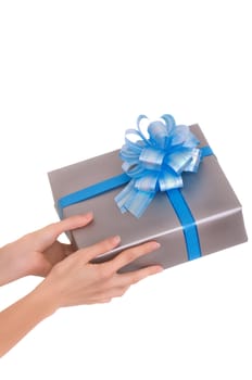 woman giving a silver box with blue bow as a gift