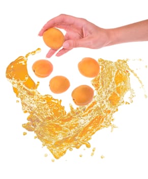 apricot in the hand and other in the water on white background