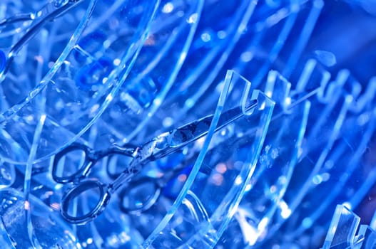 scissors on the blue abstract background for making hairdressing