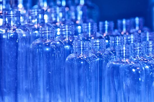 transparent empty bottles as a containers for shampoo for background