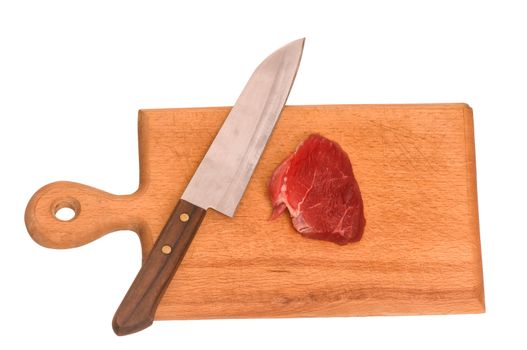 Slices of the meat on the board with knife on the kitchen
