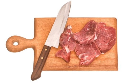 Slices of the meat on the board with knife on the kitchen