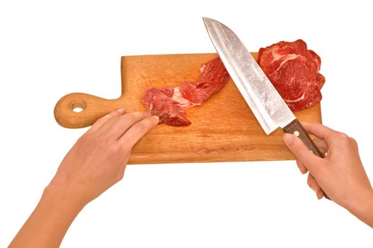 Slices of the meat on the board with knife on the kitchen