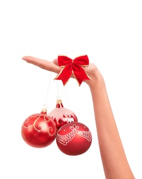 three Christmas-tree balls in the hand on white background
