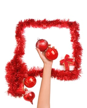 Frame decorated with Christmas-tree decorations