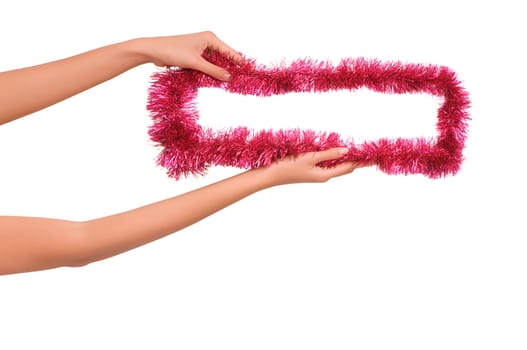 Frame decorated with Christmas-tree decorations in the woman's hands