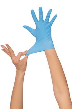 doctor putting on blue sterilized medical glove for making operation