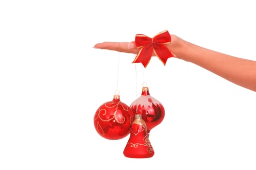 three Christmas-tree balls in the hand on white background
