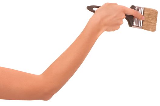 The woman draws the brush on the wall
