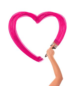 painter drawing pink heart on the wall as a symbol of love