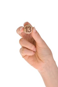 thirteenth bingo ball in the hand on white background