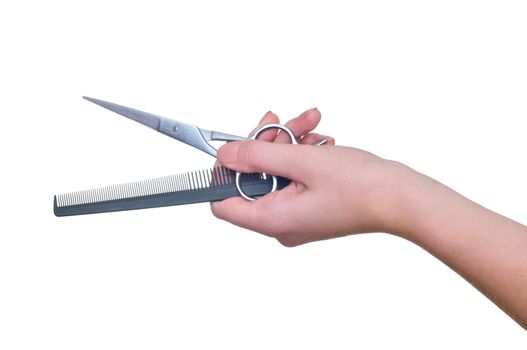 Scissors and comb in the hand on white background
