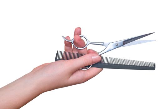 scissors and comb in the hand on white background